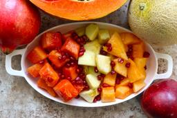 Muskmelon papaya apple pomegranate fruit bowl