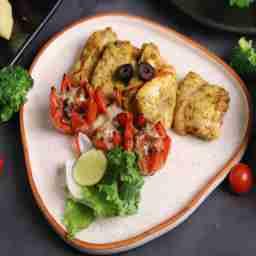 Pan roasted kasundi chicken served with grilled tomato