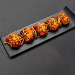 Tossed schezwan chicken momos.