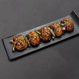 Tossed manchurian chicken momos .
